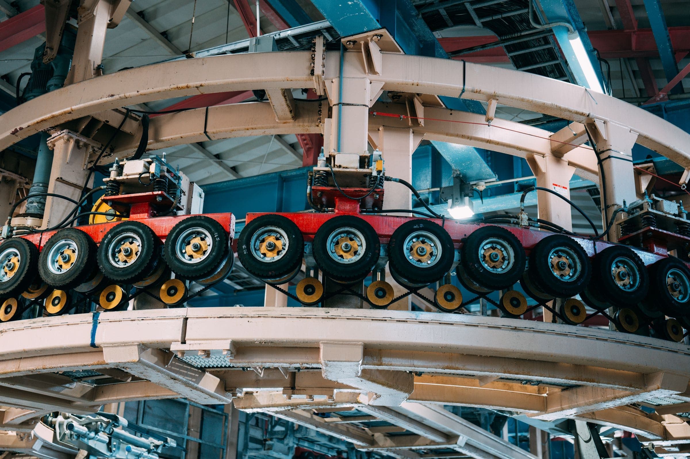 Overhead conveyor carrying wheel assemblies through a factory